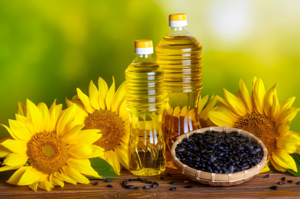 sunflower oil and sunflower seeds on wooden table
